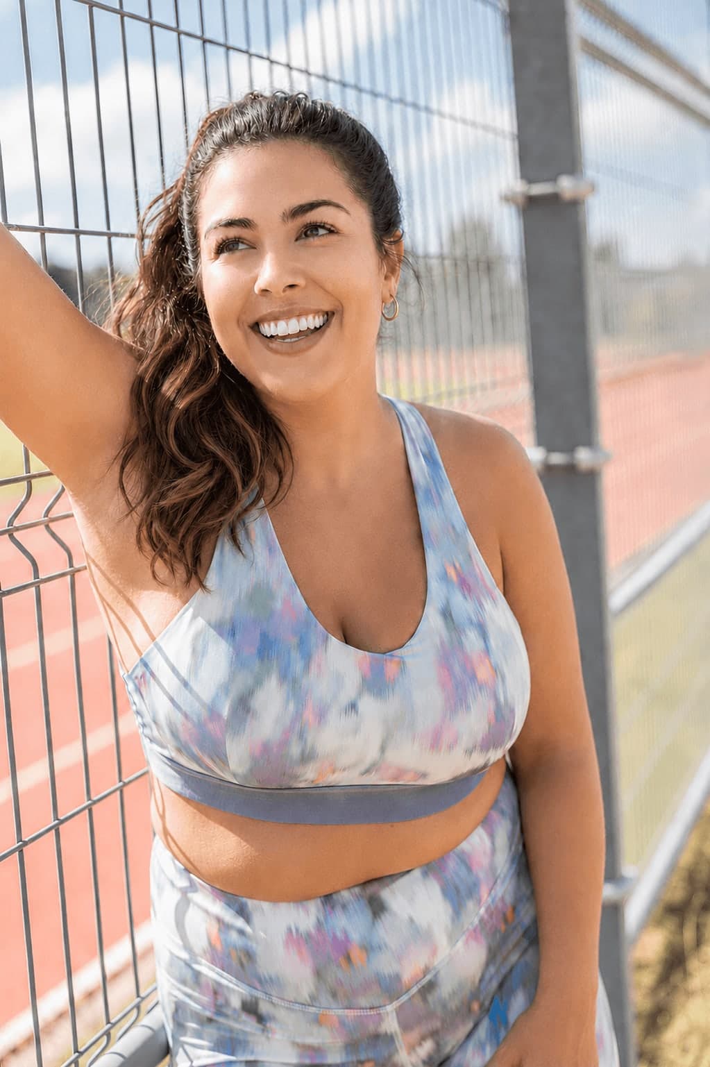 Woman smiling at an outdoor running track
